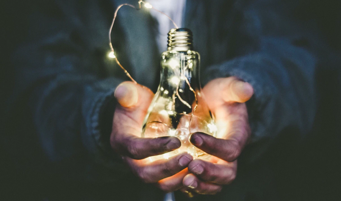 Man holding lightbulb to symbolize having an idea for starting an online business with WordPress